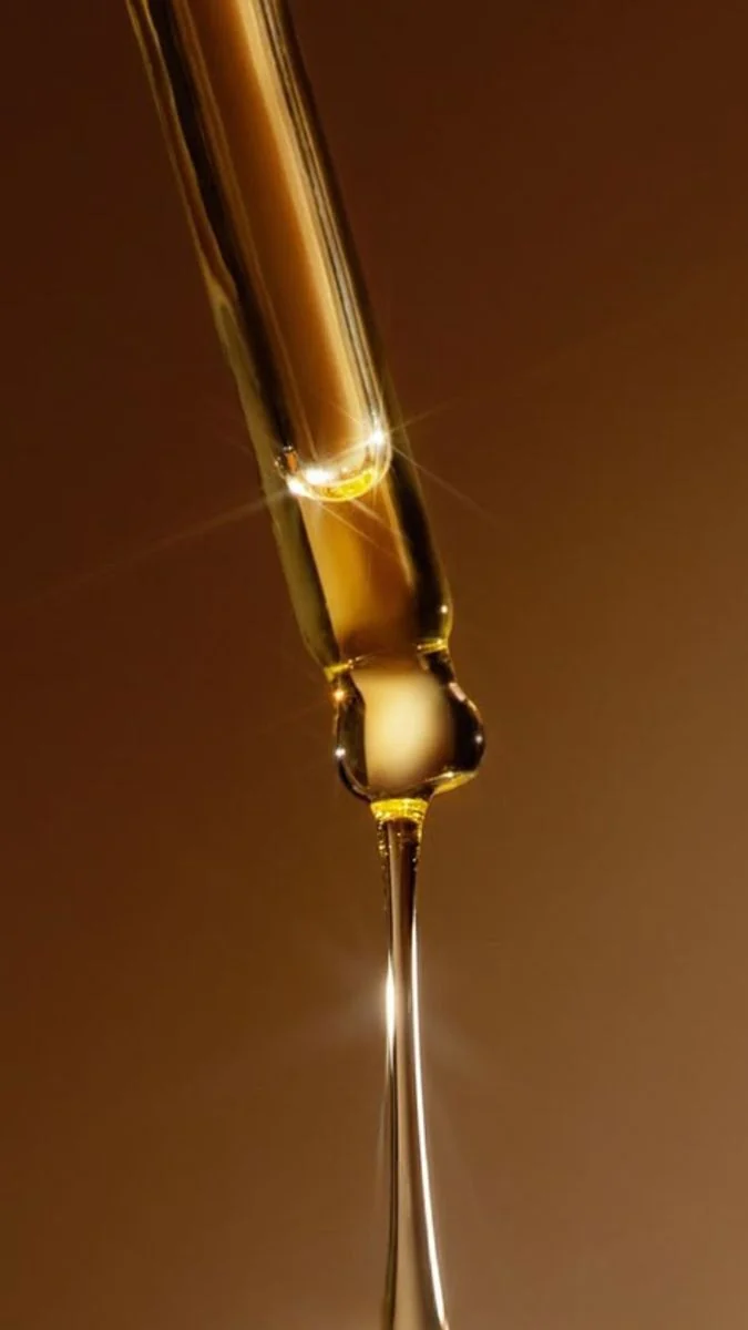 Serum flowing from a glass dropper